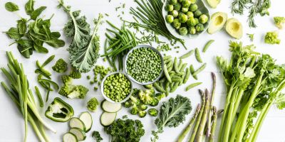 Green vegetables and herbs arranged flat lay