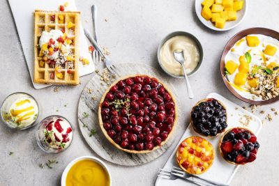 Waffles and yoghurt bowls topped with mixed frozen fruit
