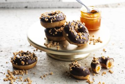 Chocolate donuts with apricot amaretti filling and almond topping
