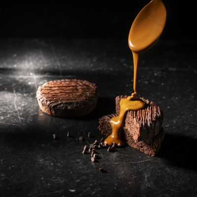 Healthy cake with caramel pour, dramatic lighting