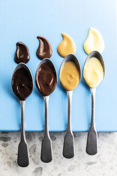 Spoons dipped in colorful dessert swatches