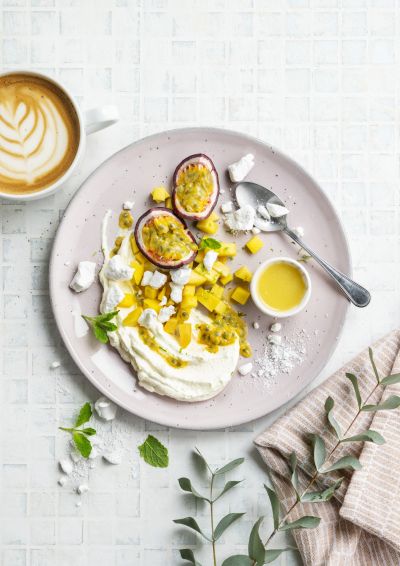 Pavlova with lime, mango, passion fruit and mint