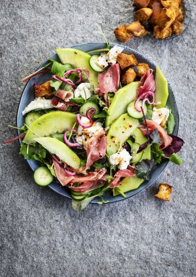 Serrano ham salad with melon, cucumber and herb leaves
