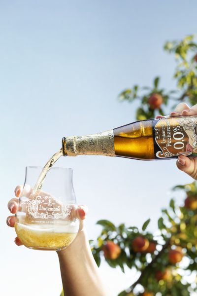 Pecheresse Bottle With The Tumbler Glass The Bottle Pouring Into The Glass &mdash; Lindemans campaign photography by Foodphoto