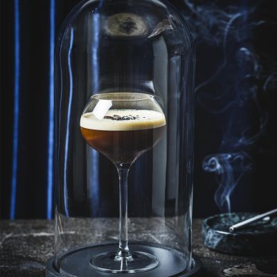 Espresso martini served under a smoked glass dome