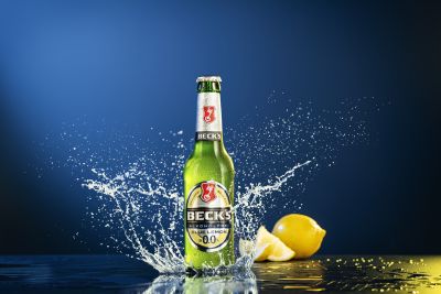 Becks beer bottle with water splash and lemon