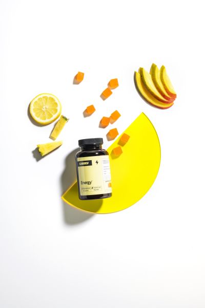 Energy supplement jar styled with citrus fruit, top-down shot