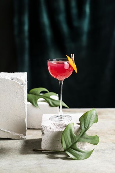 Botaniets cosmopolitan cocktail with orange twist and greenery