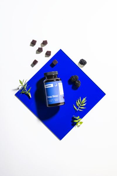 Deep Sleep supplement jar styled with herbs, top-down shot