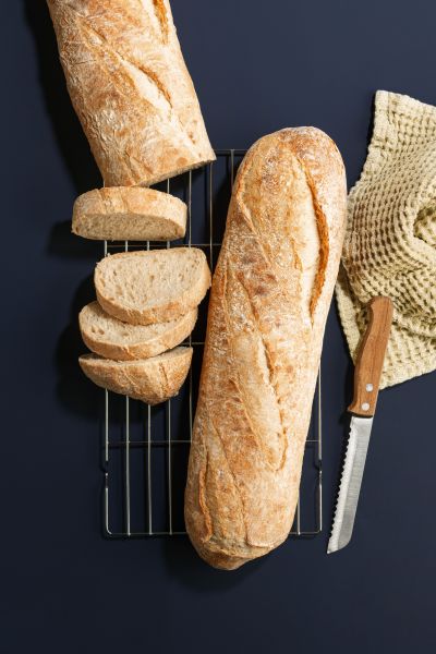 Sliced white baguette on a cooling rack