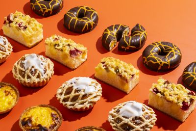 Assorted sweet pastries arranged on an orange background