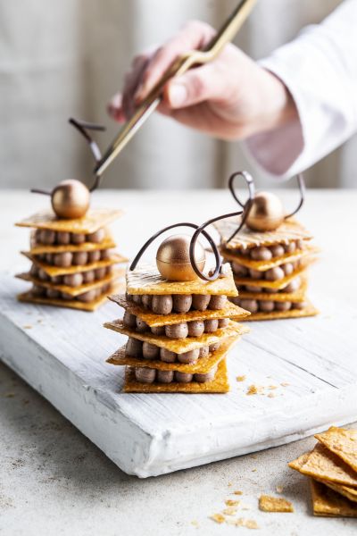 Caramelized puff pastry towers with chocolate garnish