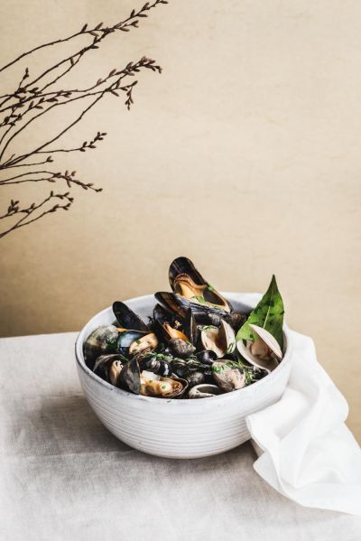 Bowl of mussels styled with a linen napkin